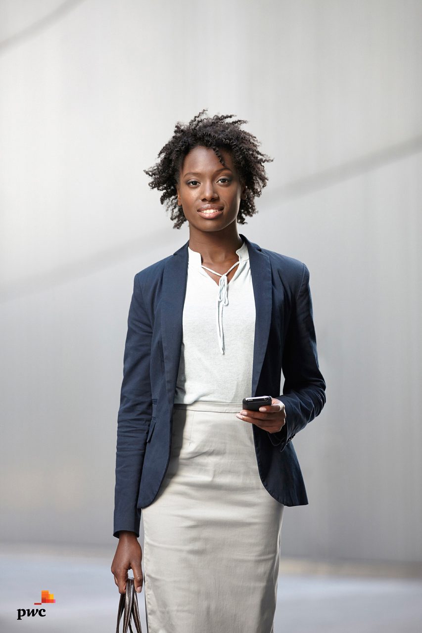Business woman in city street smiling to camera, corporate photography portrait